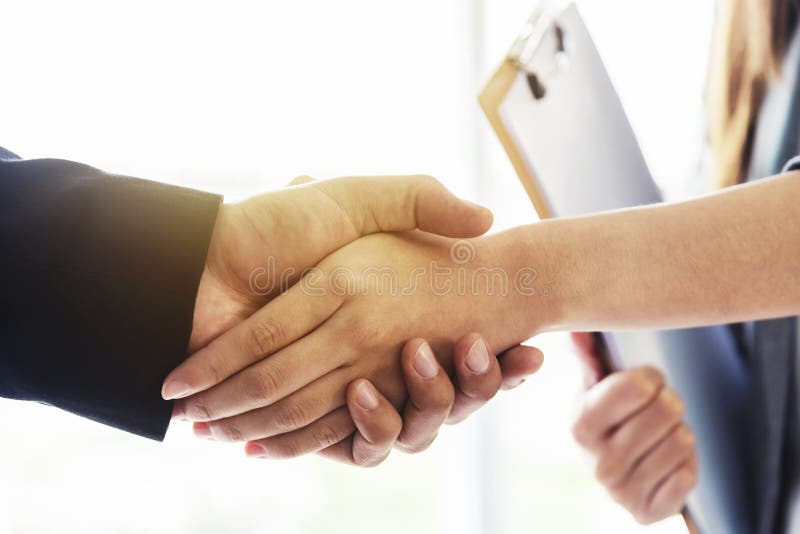 Success business deal concept. Closeup of business people handshaking after finished deal in office royalty free stock images Success business deal concept. Closeup of business people handshaking after finished deal in office royalty free stock images