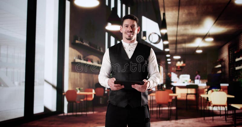 Success In The Cafe: Latino Owner Using Tablet stock photos