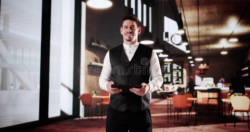 Success In The Cafe: Latino Owner Using Tablet royalty free stock image