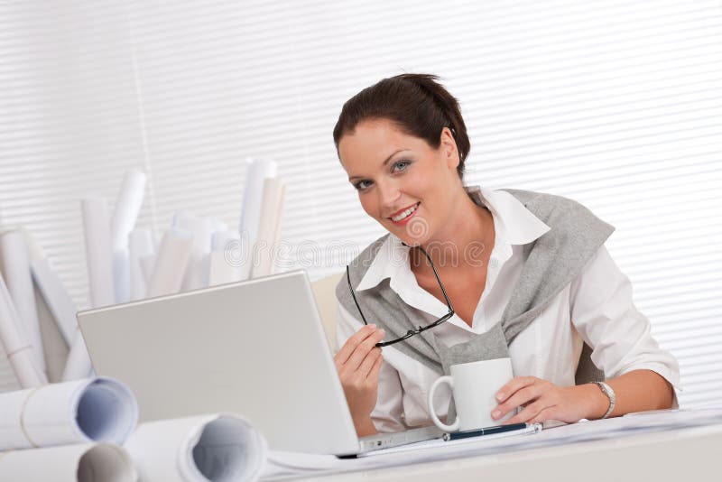 Successful architect woman at office with laptop