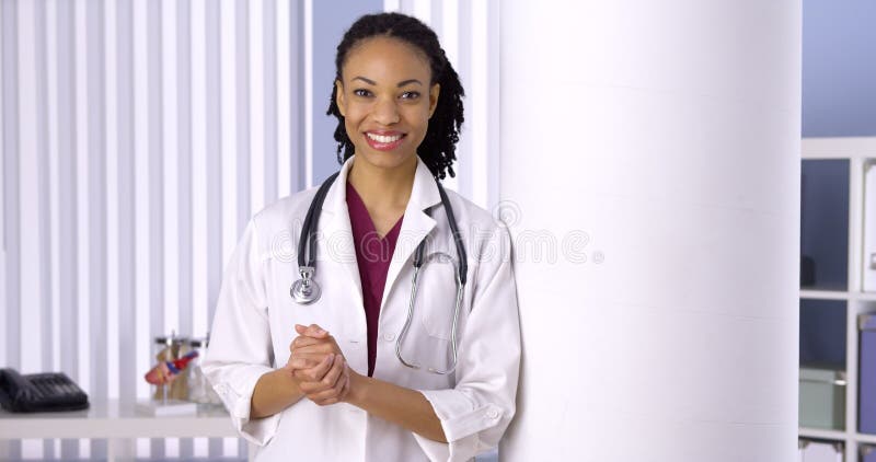 Successful black woman doctor smiling in office