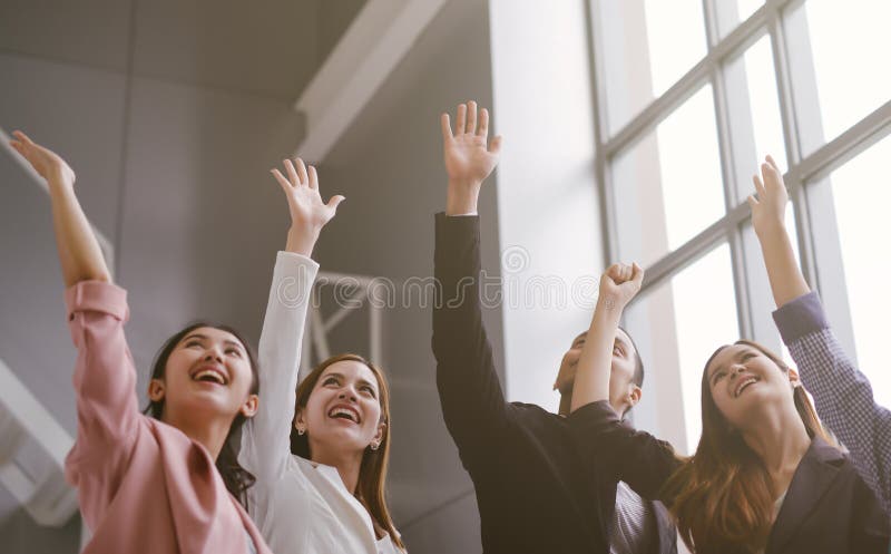 Successful of Business People Celebrating In office. Group of Happy business team hands raised for success and winning. stock images