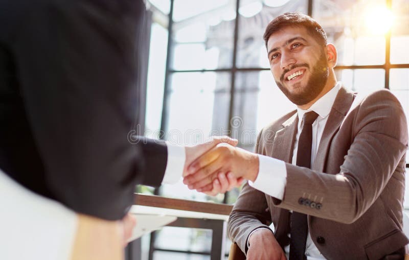 Business shaking hands, finishing up meeting. Successful businessmen handshaking after good deal. stock photos