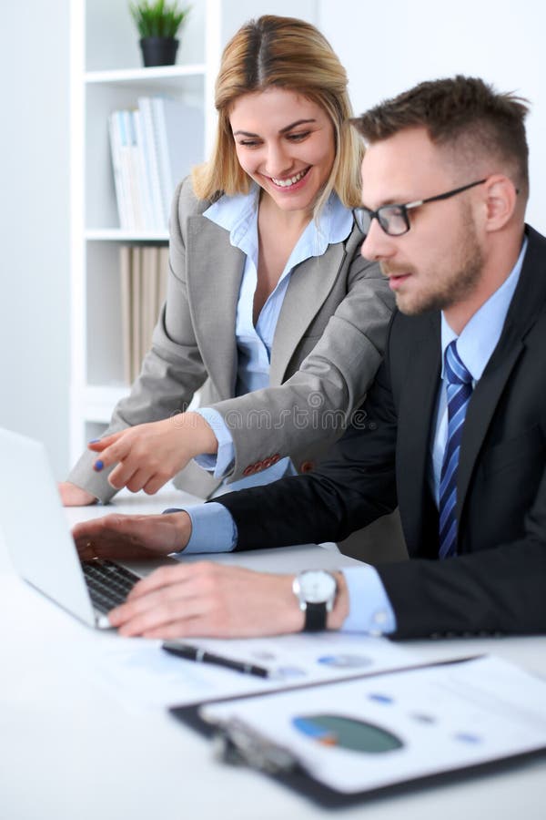 Successful business people working at meeting in office background