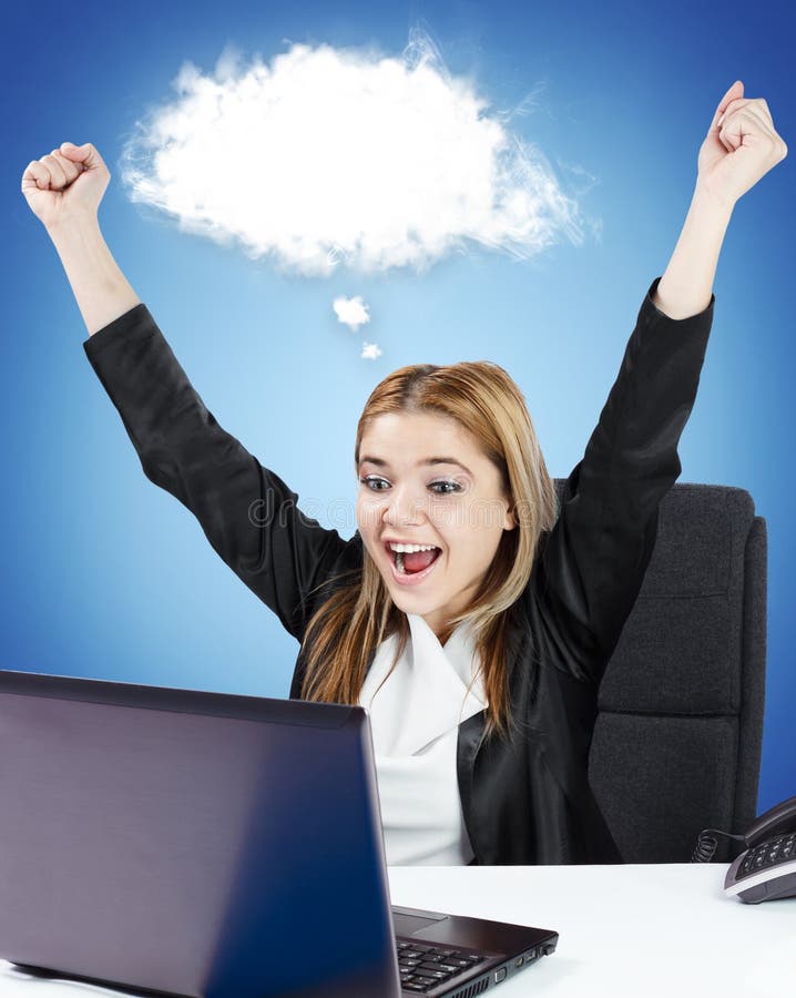 Successful business woman sitting at her desk in front of laptop. White cloud for custom text.