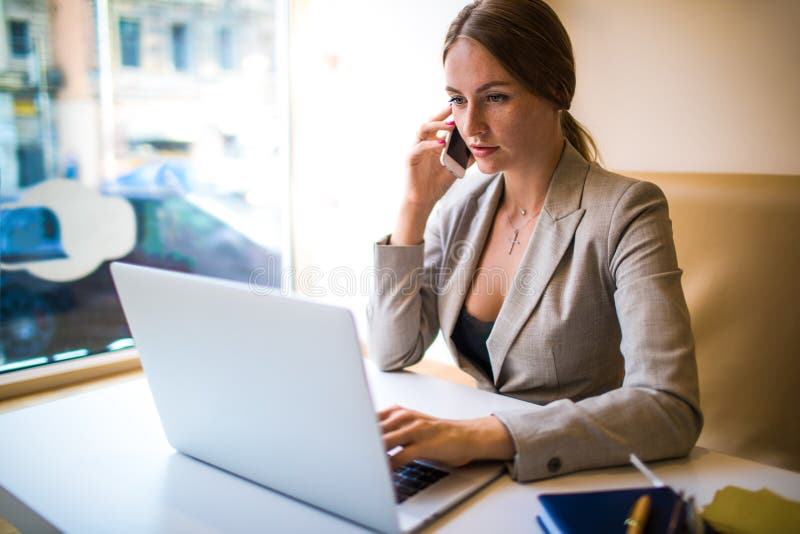 Female editor having cellphone conversation stock image Female editor having cellphone conversation stock image