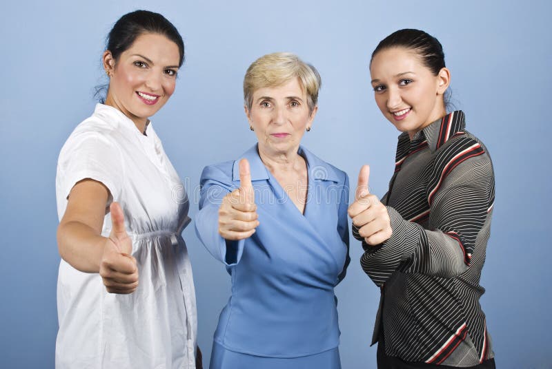 Successful business women giving thumbs up