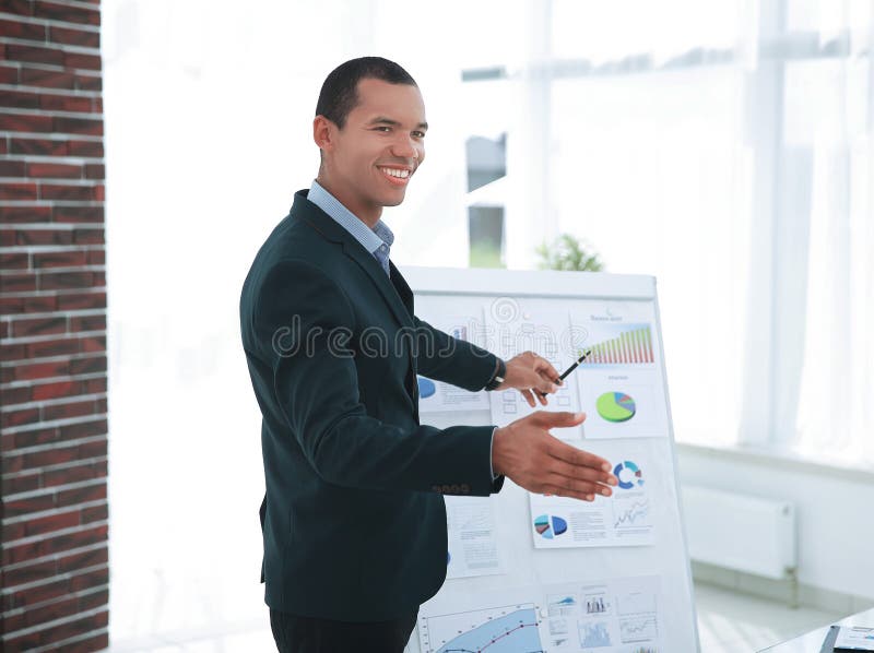 Successful businessman pointing to a flip chart with the financial information. stock photography Successful businessman pointing to a flip chart with the financial information. stock photography