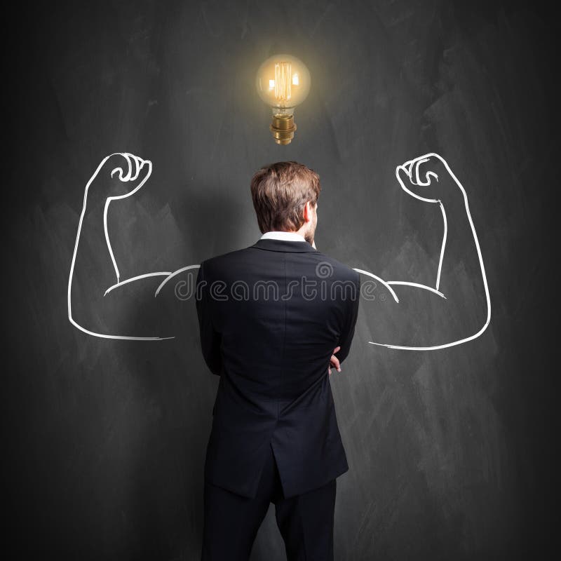 Successful businessman standing in front of a blackboard with a bright lightbulb over his head royalty free stock photos Successful businessman standing in front of a blackboard with a bright lightbulb over his head royalty free stock photos