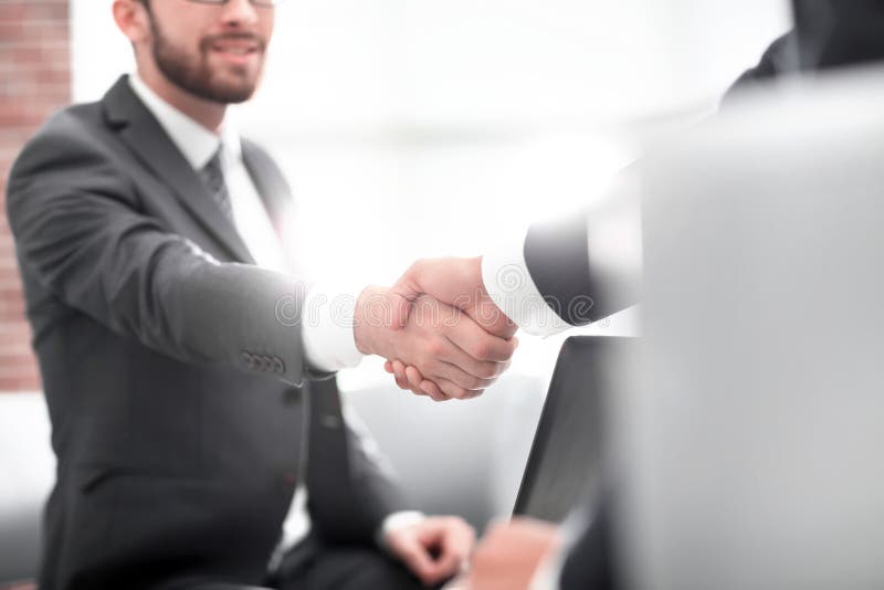 Confident businessman shaking hands at officce stock images Confident businessman shaking hands at officce stock images