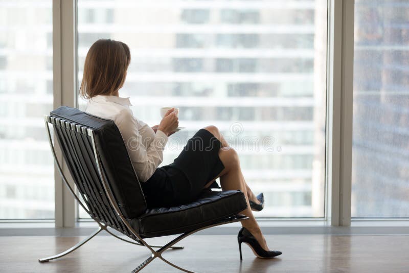 Successful businesswoman sitting in comfortable chair enjoying v stock images Successful businesswoman sitting in comfortable chair enjoying v stock images