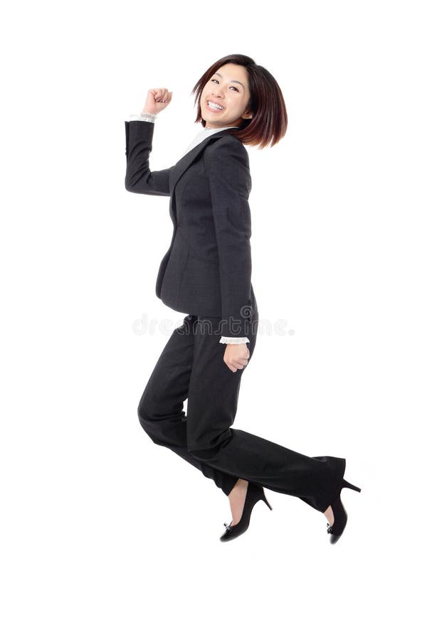 Successful businesswoman in suit jumping joyful royalty free stock photo