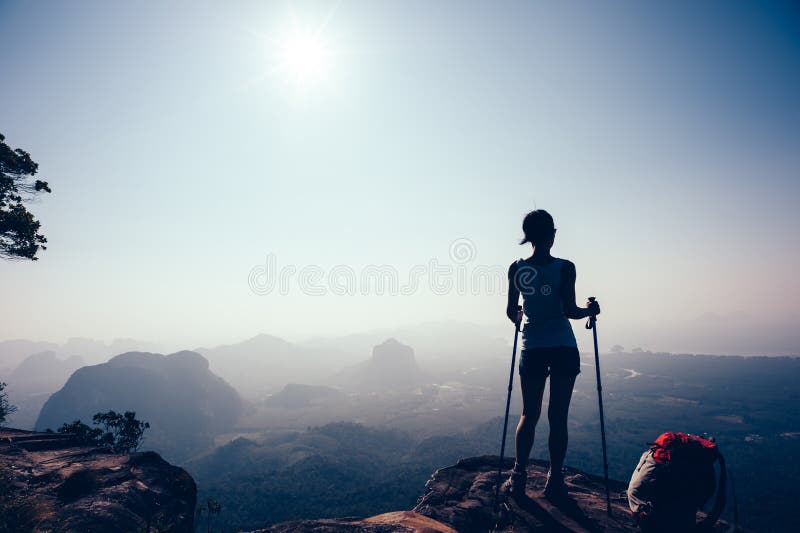 Hiker hiking on sunset mountain peak stock photos Hiker hiking on sunset mountain peak stock photos