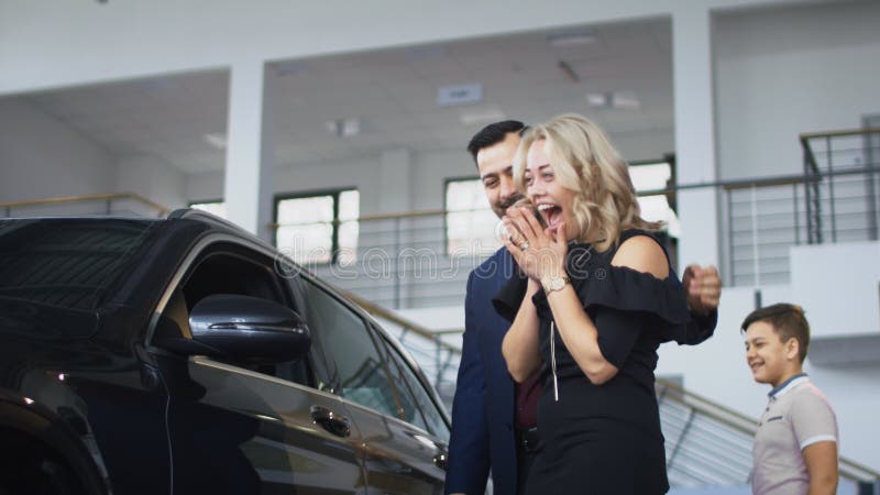 Happy family getting new car in salon stock photography Happy family getting new car in salon stock photography