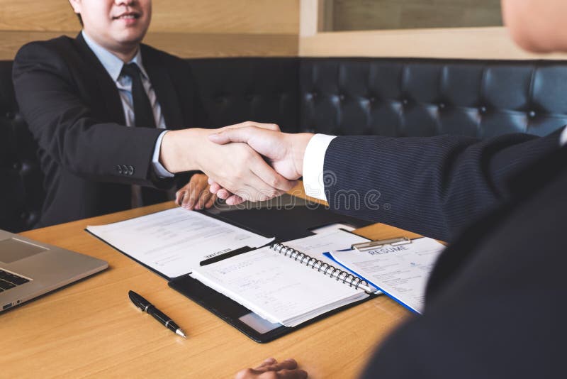 Successful job interview with boss and employee shaking hands af stock images Successful job interview with boss and employee shaking hands af stock images