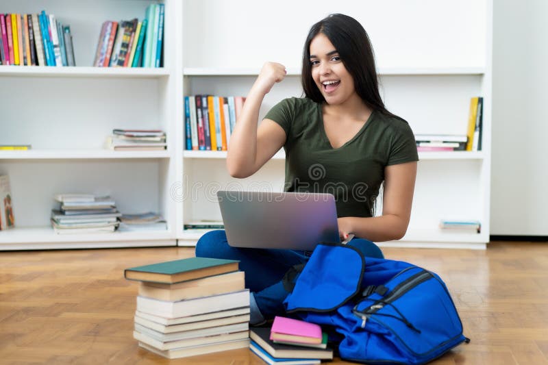 Successful spanish computer science student with laptop royalty free stock photo