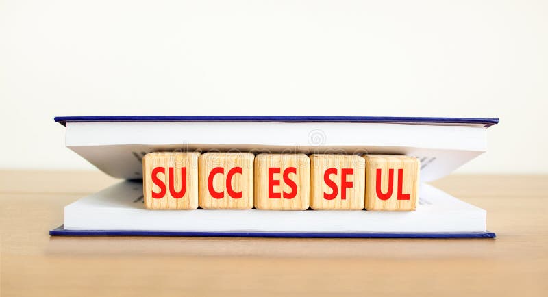 Successful symbol. Concept word Successful on beautiful wooden cubes in book. Beautiful wooden table white background. Business royalty free stock photos