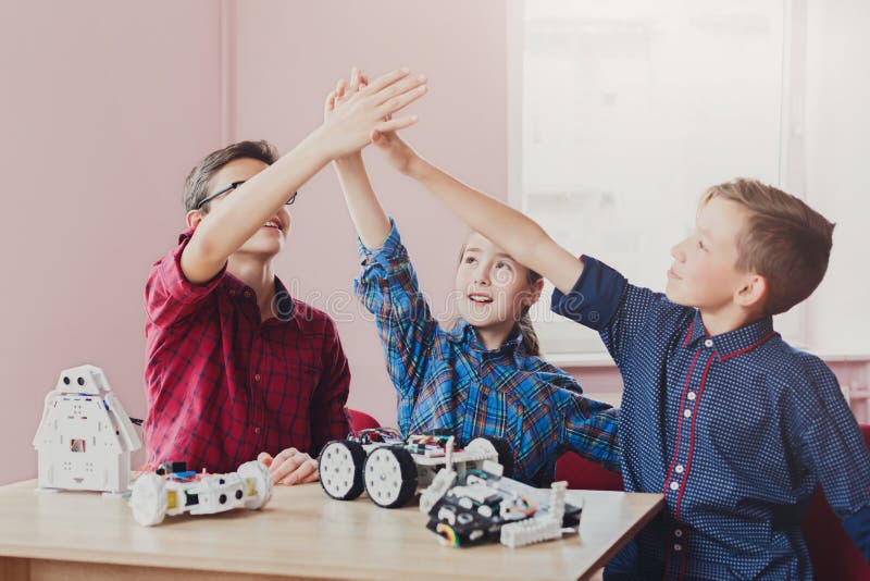 Stem education. Kids creating robots, success royalty free stock photos