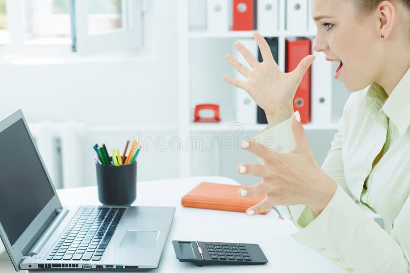 Successful young atractive woman looking on a laptop. stock photo Successful young atractive woman looking on a laptop. stock photo