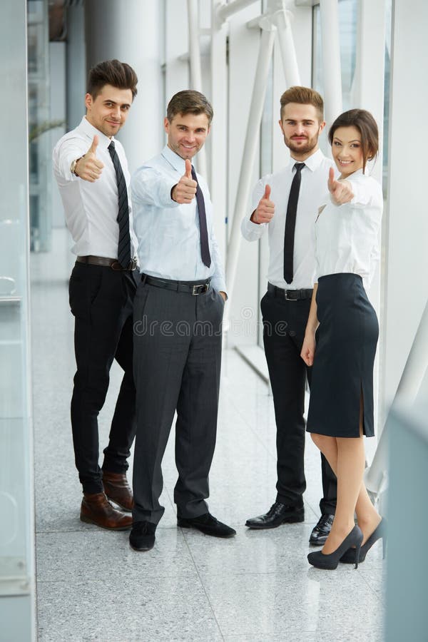 Successful young business people showing thumbs royalty free stock image