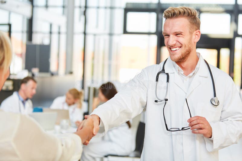 Successful young doctor shaking hands royalty free stock photos