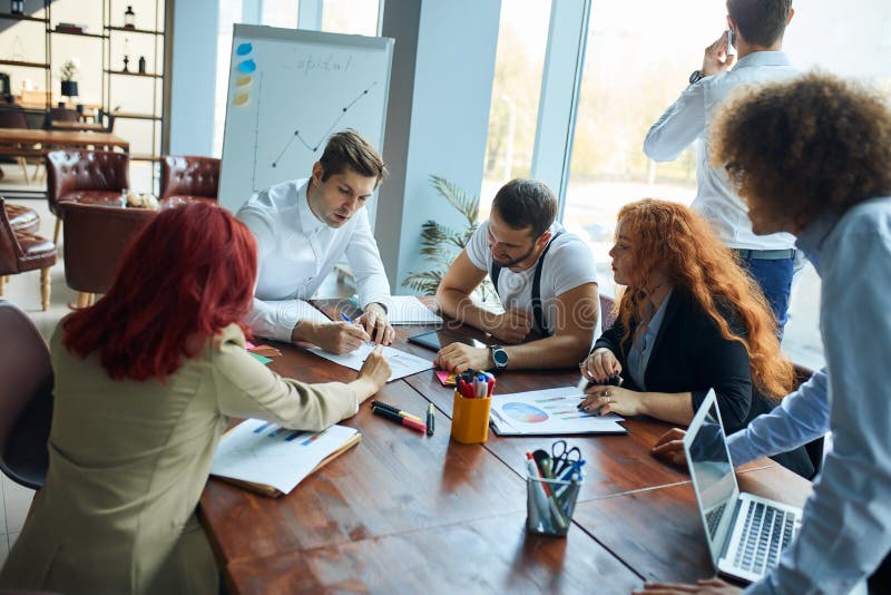Teamwork process of young team of caucasian coworkers making great business discussion in modern office royalty free stock images Teamwork process of young team of caucasian coworkers making great business discussion in modern office royalty free stock images