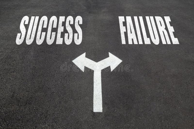 Success vs failure choice concept, two direction arrows on asphalt. Success vs failure choice concept, two direction arrows on asphalt.