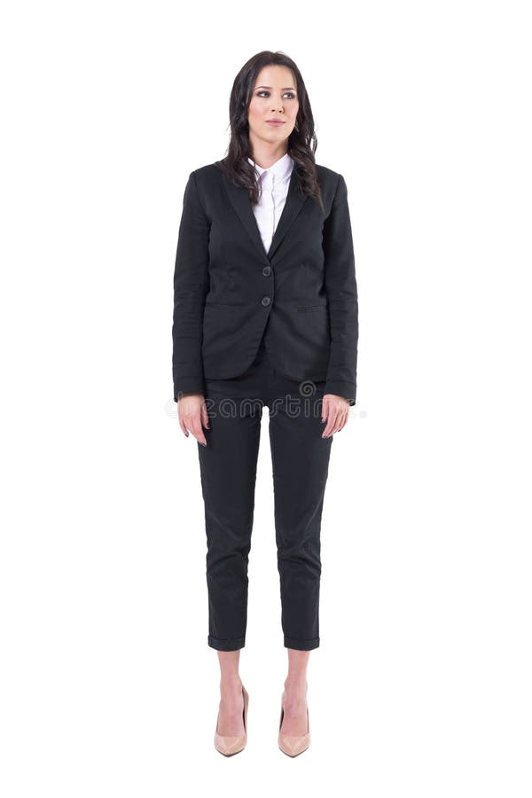 Successful young pretty business woman in black suit standing with arms down looking away. Full body isolated on white background. Successful young pretty business woman in black suit standing with arms down looking away. Full body isolated on white background