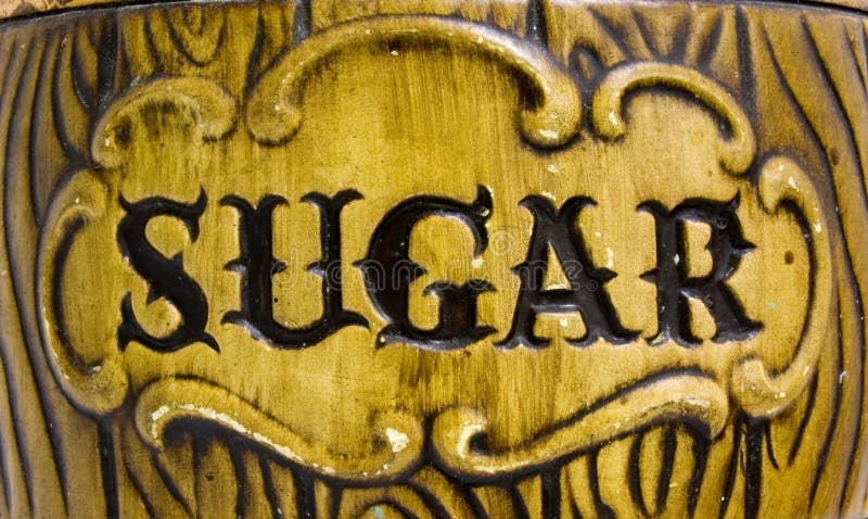 The word sugar on an antique ceramic jar