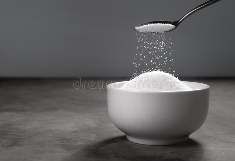 Sugar Being Poured from Spoon into a Bowl Empty Ready for Your P Stock