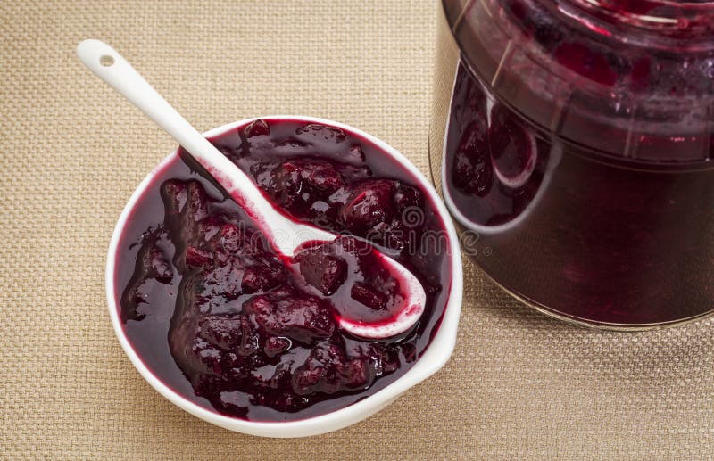 Sugar free cranberry sauce with addiiton of blueberry, apples and honey - small bowl and jar