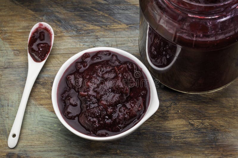 Sugar free cranberry sauce with addition of blueberry, apples and honey - small bowl, jar and spoon