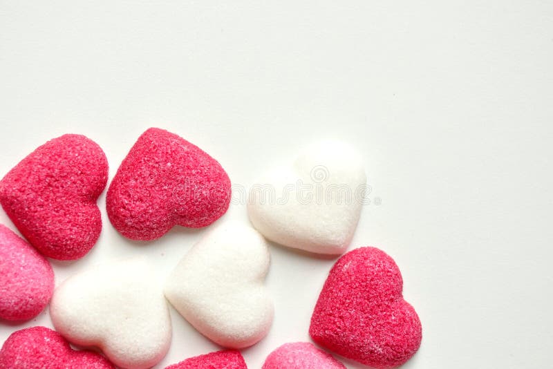 Sugar with heart shapes on white background