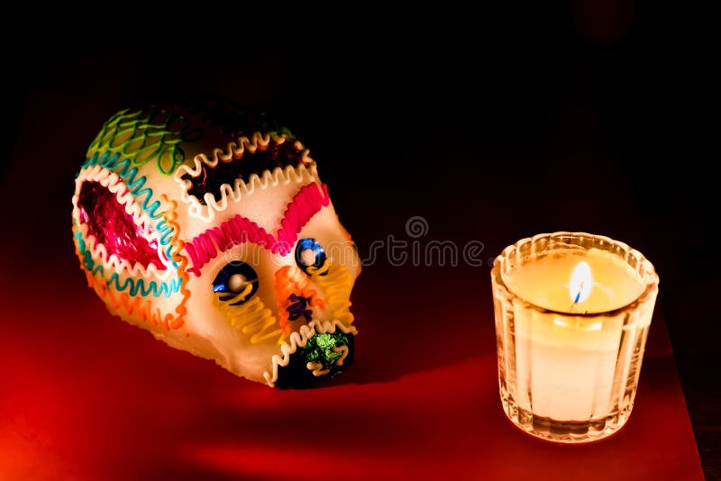 Sugar skull and candles - Calaverita - Ofrenda Dia de muertos. Day of dead celebration, Sugar skull candy and candles - Celebracion dia de muertos royalty free stock images