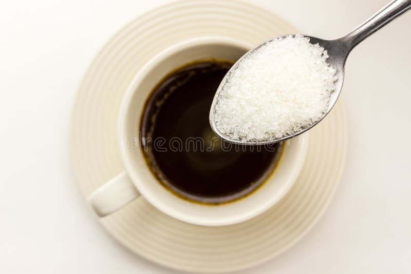 Sugar in the spoon pour into coffee cup. Sugar in the spoon pour into coffee cup.