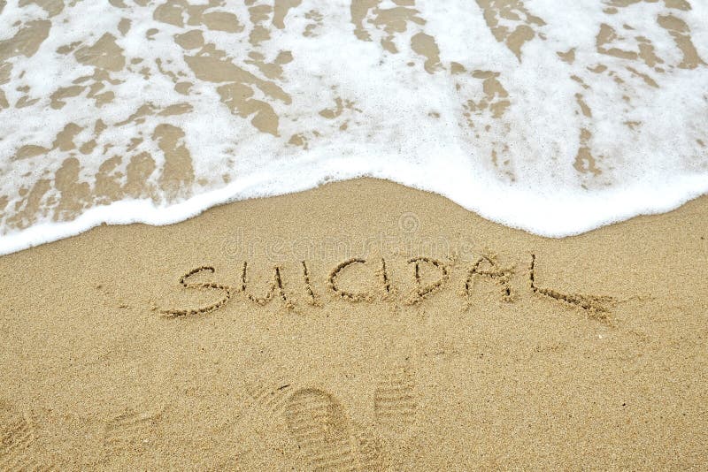 SUICIDAL written on sand