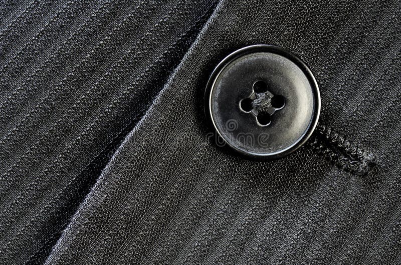 Detail of closeup of suit button on pin stripped cloth. Detail of closeup of suit button on pin stripped cloth