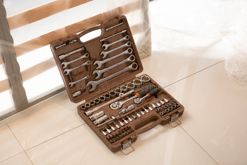 Suitcase full of various tools. adjustable wrench, screwdriver stock images