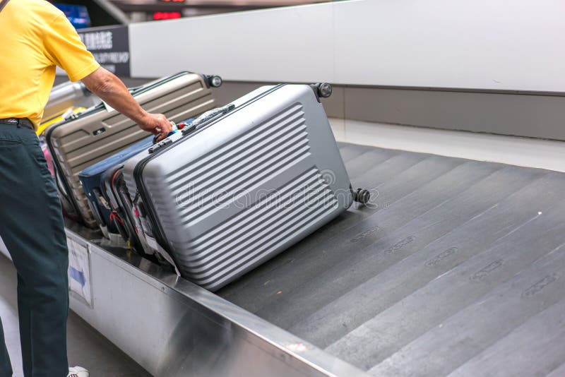 Suitcase or Luggage with Conveyor Belt in the Airport Stock Image