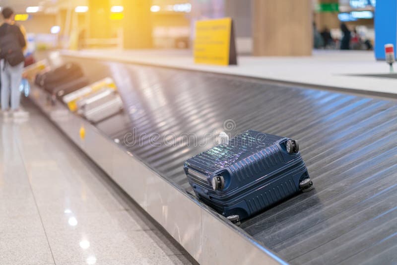 Suitcase or Luggage with Conveyor Belt in the Airport Stock Photo