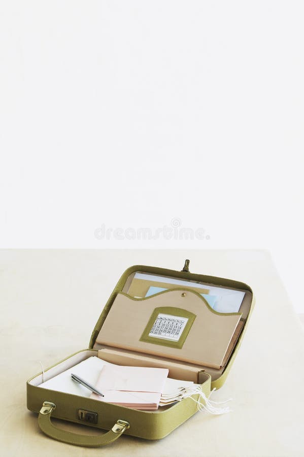 Suitcase with Stationery Items Elevated View Studio Shot Stock Photo