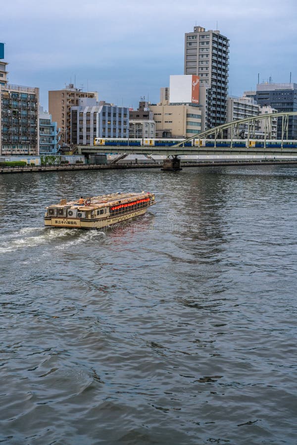 Sumida-ku, Tokyo - July 28, 2017: A boat in Sumida river and Yanagi-bashi bridge from Ryogoku-bashi Bridge