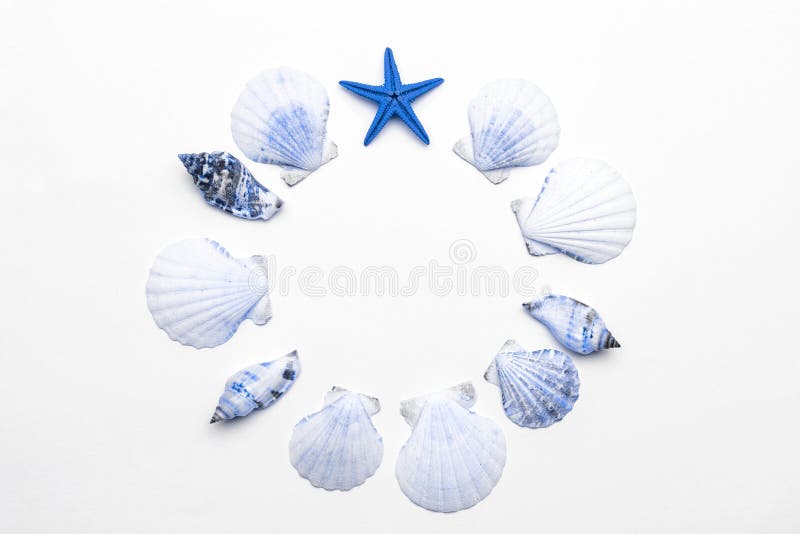 Summer background beach with aquamarine light blue shells and starfish in shape frame isolated on white backdrop. Top view travel