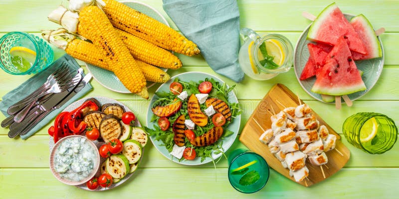 Summer bbq party concept - grilled chicken, vegetables, corn, salad, top view