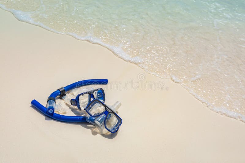 Summer sport, beach activity beach recreational banner. Diving goggles snorkel gear on white sand near sea waves