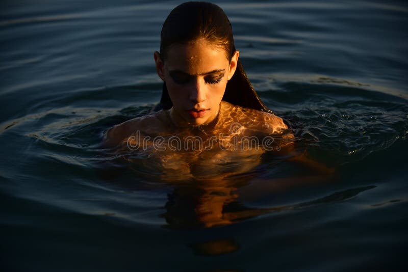 Summer beautiful Girl. Slim young woman against blue water, good summer resort. Lovely fit female model on sea.