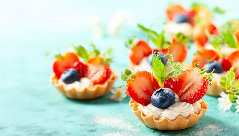 Summer berry tartlets  with cream and fresh berries