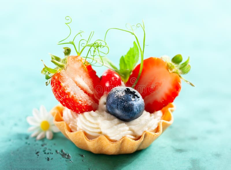 Summer berry tartlets  with cream and fresh berries