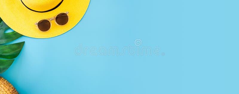 Summer blue banner with yellow hat ,sunglasses and monstera leaf on blue background top view royalty free stock photo Summer blue banner with yellow hat ,sunglasses and monstera leaf on blue background top view royalty free stock photo