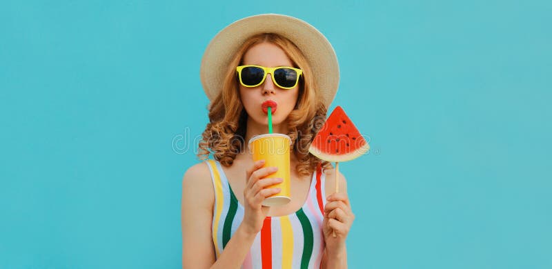 Summer colorful portrait beautiful young woman drinking juice with lollipop or ice cream shaped slice of watermelon wearing a